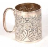 A Victorian silver christening mug, embossed and chased with a foliate design around a central