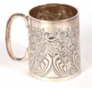 A Victorian silver christening mug, embossed and chased with a foliate design around a central