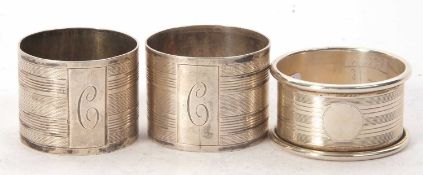 A pair of George VI silver serviette rings, engine turned decorated around the letter C,