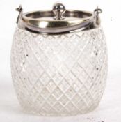 A cut glass biscuit barrel with a silver plated lid and collar with a swing handle, 13cm tall