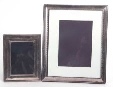 A large silver plated photograph frame of rectangular form, easel backed, 29 x 24cm together with