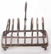 A Victorian silver large toast rack, six divisions with central loop carrying handle on a