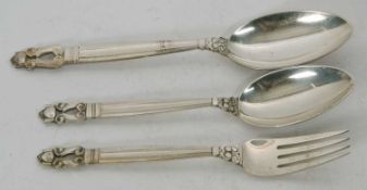 A George Jenson sterling acorn pattern dessert fork and spoon, together with a serving spoon in