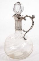 A Victorian glass and silver mounted claret jug, the dimpled glass body with a wrythen design having
