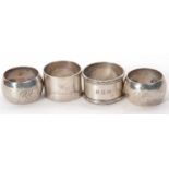 A group of four hallmarked silver serviette rings to include a pair of Edwardian examples,