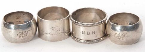 A group of four hallmarked silver serviette rings to include a pair of Edwardian examples,