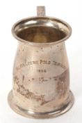 An Indian colonial white metal tankard of spreading baluster form, angular scroll handle,