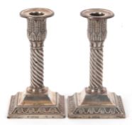 A pair of Edward VII silver candlestick with acanthus leaf caps, fluted swirl design columns to a