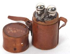A vintage leather travel case double glass spirit flask, both with screw on metal bulbous lids,