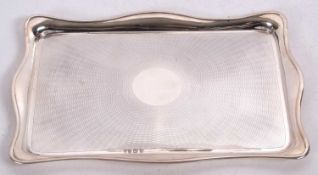 Edwardian silver dressing table tray, of shaped rectangular form, having a wavy edge, the centre