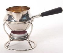 A small George V silver brandy saucepan and warmer on a burner stand having a plain round baluster