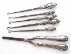 Mixed Lot: Antique silver handled curling tongs, together with five silver handled button hooks (6)