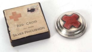 A silver Red Cross pin cushion, 1915 with raised central red velvet cushion, loaded base, hallmarked