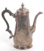 A hallmarked silver coffee pot in George II style, of plain design and of slight baluster shape on