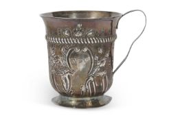 A George III silver mug with part fluted body and floral and scroll garland, framing a monogrammed