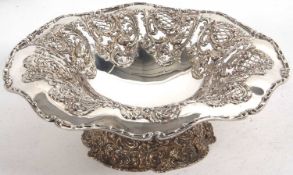 A decorative pedestal fruit bowl/centre piece, elaborately embossed and pierced with roses,