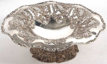 A decorative pedestal fruit bowl/centre piece, elaborately embossed and pierced with roses,