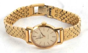An Omega Geneve lady's wristwatch, the watch has a champagne dial with baton hour markers and a