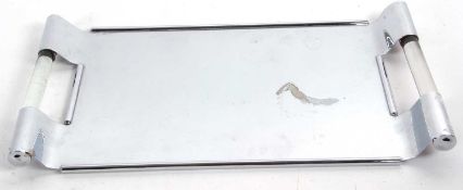 A modernist chrome tray of plain rectangular form, the swept side handles with glass inserts,