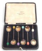 Cased set of six silver gilt and enamel bean end coffee spoons, the different coloured finials