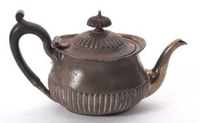 A small Victorian batchelors teapot of oval form, the dome lid and body part decorated with fluted
