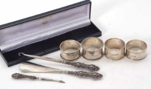 Mixed Lot: Four hallmarked silver serviette rings, various dates and makers, 76gms together with a