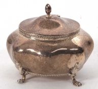 An Edwardian silver caddy of plain bombe design with hinged lid and urn finial with applied