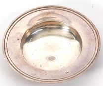 A small silver arms dish/bowl with reeded edges and having oversized hallmarks for London 1974,