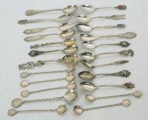 A quantity of white metal souvenir teaspoons, six with enamel detail, ten various souvenir spoons,