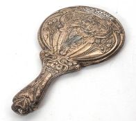 An Art Nouveau silver backed dressing table mirror decorated with a lady figure and buds, scrolls