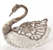 A silver and cut glass swan dish, the body of the swan is cut glass with folding wings decorated