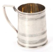 A George III small silver mug of slight tapering cylindrical form with reeded bands and angular