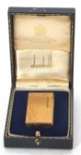 A vintage gold plated Dunhill 70 lighter in original fitted folding case