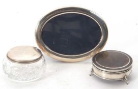 Mixed Lot: A modern silver photograph frame, oval shaped, easel backed, hallmarked for Sheffield