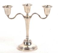 An Elizabeth II silver three branch candelabra, loaded, Birmingham 1968, makers mark for Elkington &