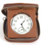 A vintage travel clock to include case and watch, the pocket watch is stamped inside the case back