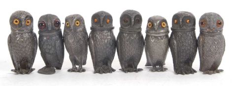 A group of eight pewter novelty screw top owl formed pepper shakers, 7cm tall (8)