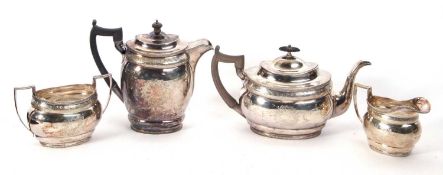 Early 20th Century four piece silver tea set of oval form with gadrooned edges, chased with foliage,