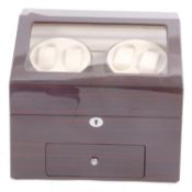 An electric watch winder box, the box features four watch winders and a large watch storage