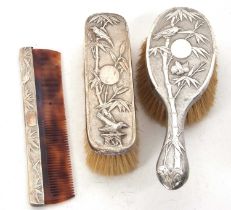 A Chinese silver circa 1900 backed hairbrush, clothes brush and comb, decorated with birds and