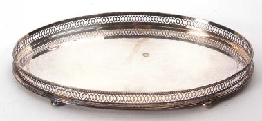 An Elizabeth II large oval shaped gallery tray of plain form with chased and pierced engraved