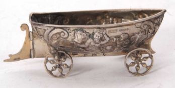 An antique continental white metal novelty pin dish in the form of a boat with articulated wheels