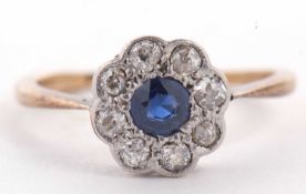 An 18ct sapphire and diamond ring, the central round sapphire surrounded by single cut diamonds, all