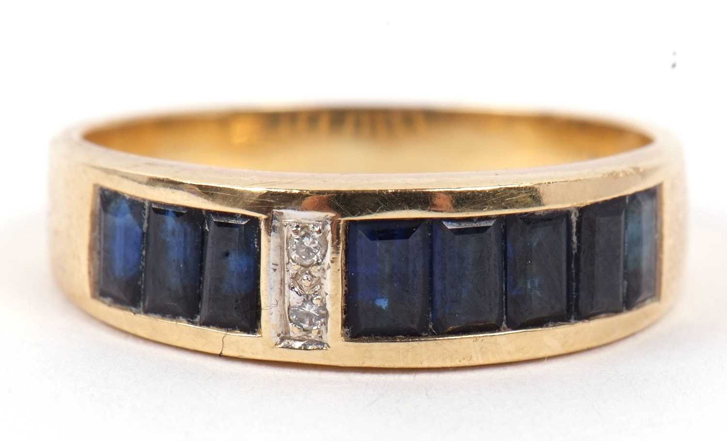 An 18ct sapphire and diamond ring, the channel set sapphires, offset with two small round - Image 3 of 9