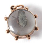 A 9ct mouse charm, the round charm with domed glazed panel to either side, containing a free