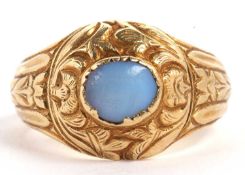 A gentleman's yellow metal and hardstone dress ring, the oval pale blue cabochon hardstone in a