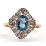 A 9ct topaz and diamond ring, the central oval topaz with an undulating surround of small round