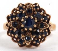 A 9ct sapphire cluster ring, the stepped flowerhead style cluster set with round sapphires, with