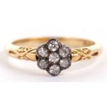 An 18ct diamond flowerhead cluster ring, the seven round diamonds set in white metal, with