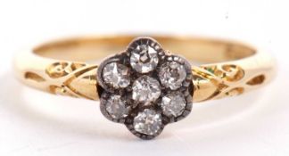 An 18ct diamond flowerhead cluster ring, the seven round diamonds set in white metal, with